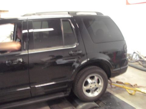 1989 Ford Probe - Black SUV on a dynamometer, likely a Ford Explorer from the early 2000s.