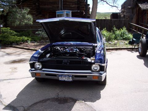 1972 Ford Ranchero - Front view of a blue 1970 Nova, engine exposed under the open hood.