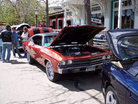 1972 Ford Ranchero - A classic red muscle car is displayed with its hood open at an outdoor event.