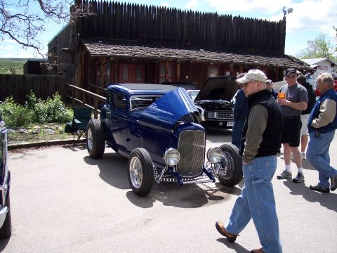 1972 Ford Ranchero - A custom blue hot rod coupe is displayed with its hood open, drawing attention at an outdoor event.