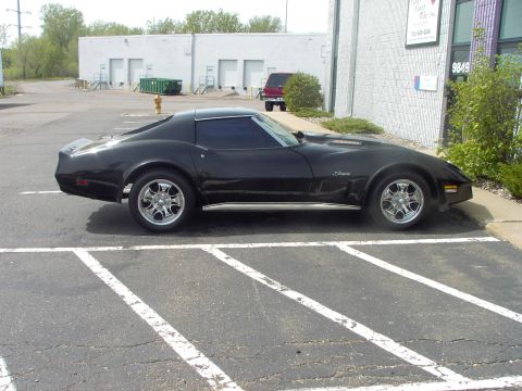 1989 Ford Probe - This black coupe is parked in a lot, showing its side profile.