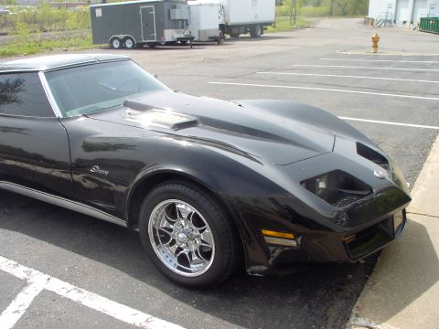 1989 Ford Probe - This black Chevrolet Corvette C3 features a prominent hood scoop and custom wheels, suggesting performance modifications.
