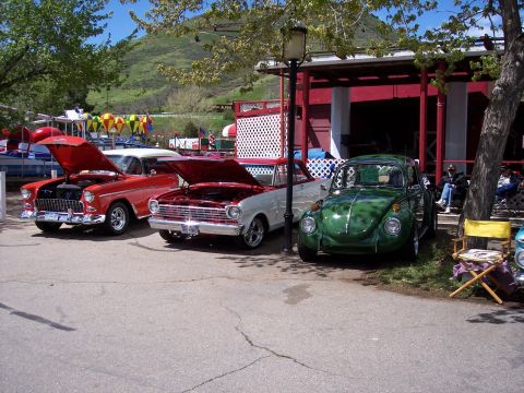 1972 Ford Ranchero - A green 1972 Volkswagen Beetle is parked next to other classic cars under a tree.