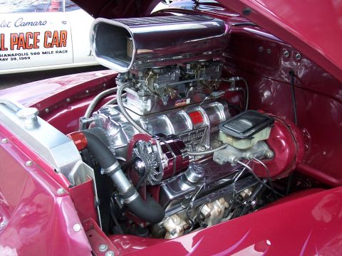 1972 Ford Ranchero - A highly modified V8 engine with a prominent air intake scoop and polished components is displayed.