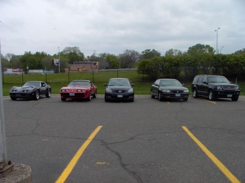 1989 Ford Probe - A collection of vehicles parked in an outdoor lot under an overcast sky.