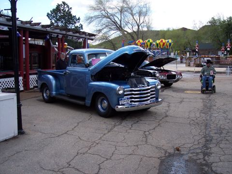 1972 Ford Ranchero - A classic blue pickup truck is displayed with its hood open, parked next to another vehicle.