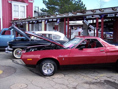 1972 Ford Ranchero - A red 1972 Ford Ranchero 500 is parked with its hood open, alongside other classic vehicles.