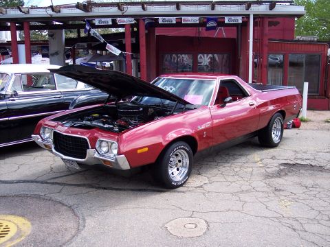 1972 Ford Ranchero - A red 1972 Ford Ranchero is displayed with its hood up, parked beside another vehicle.