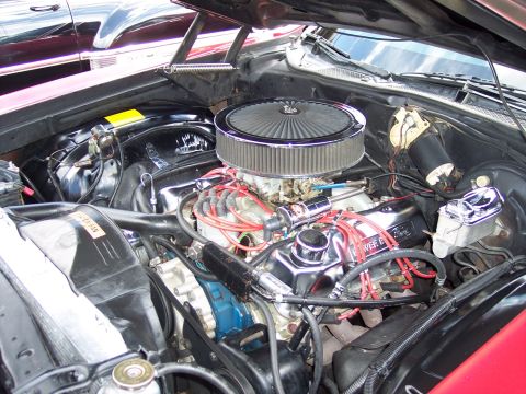 1972 Ford Ranchero - The engine bay of a 1972 Ford Ranchero shows a V8 engine with aftermarket chrome components.