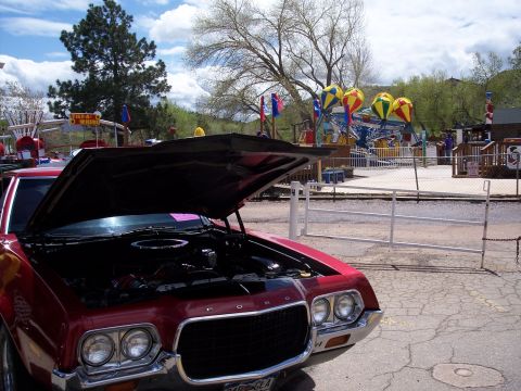 1972 Ford Ranchero - 1972 Ford Ranchero with engine exposed, parked at an outdoor amusement park.