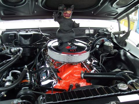 1972 Ford Ranchero - Engine bay view of a 1967 Chevrolet Impala, a 427 big-block engine and a decorative rat figurine.