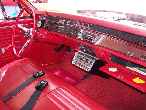 1972 Ford Ranchero - Interior view of a classic red 1966 Chevrolet Chevelle, its distinctive dashboard and seating.