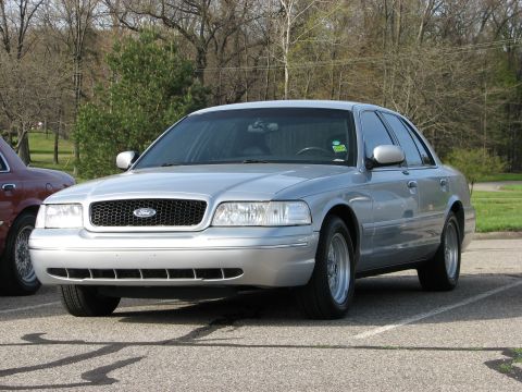 2003 Ford Crown Victoria - Silver 2003 Ford Crown Victoria parked in a lot with another vehicle visible.