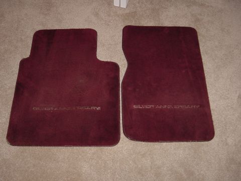 1991 Ford Bronco - Pair of maroon floor mats embossed with "SILVER ANNIVERSARY" text.