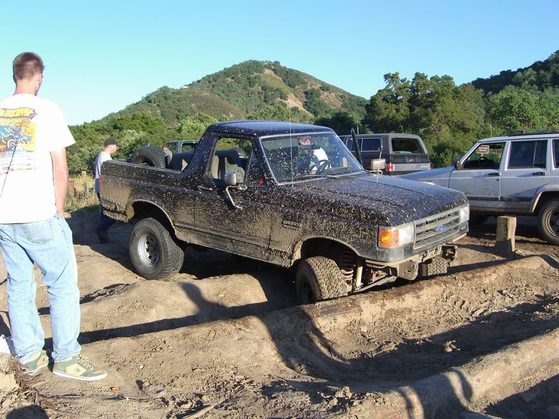 Black Ford Bronco navigating an off-road obstacle course