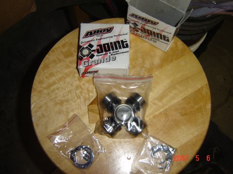 1993 Ford Bronco - U-joint and associated parts are laid out on a wooden surface.