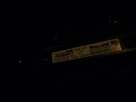 2000 Ford Crown Victoria - Close-up of a Whelen Talon single dash light label with part and serial numbers visible.