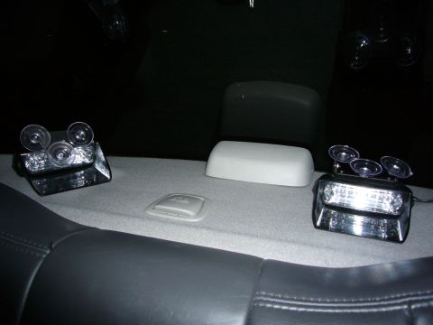 2000 Ford Crown Victoria - Interior view of a car's rear deck with emergency lights and a white dome cover.