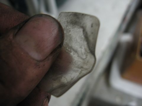 1974 Ford F-100 - A dirty plastic part is held in a hand, with a watermark for Supermotors.net visible.