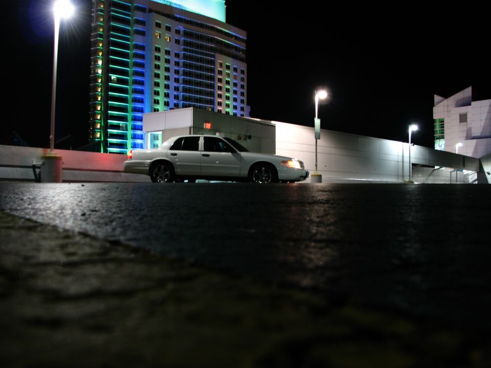 White 2003 Ford Crown Victoria sedan parked at night, side view