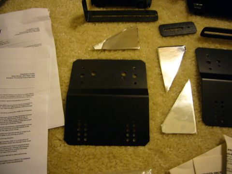2000 Ford Crown Victoria - The photo displays vehicle mounting hardware and an installation guide for a dash light.