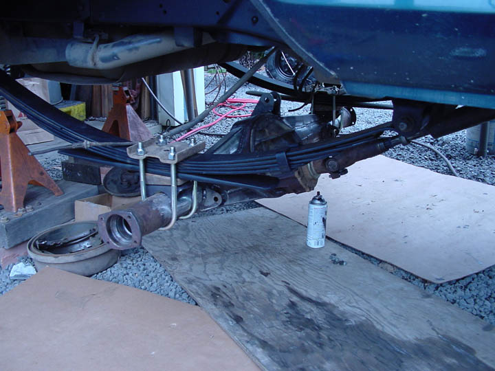 Rear axle and leaf springs with U-bolts and spray can