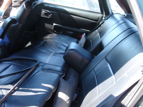 1993 Ford Taurus - Interior view of black leather rear seats and door panel.