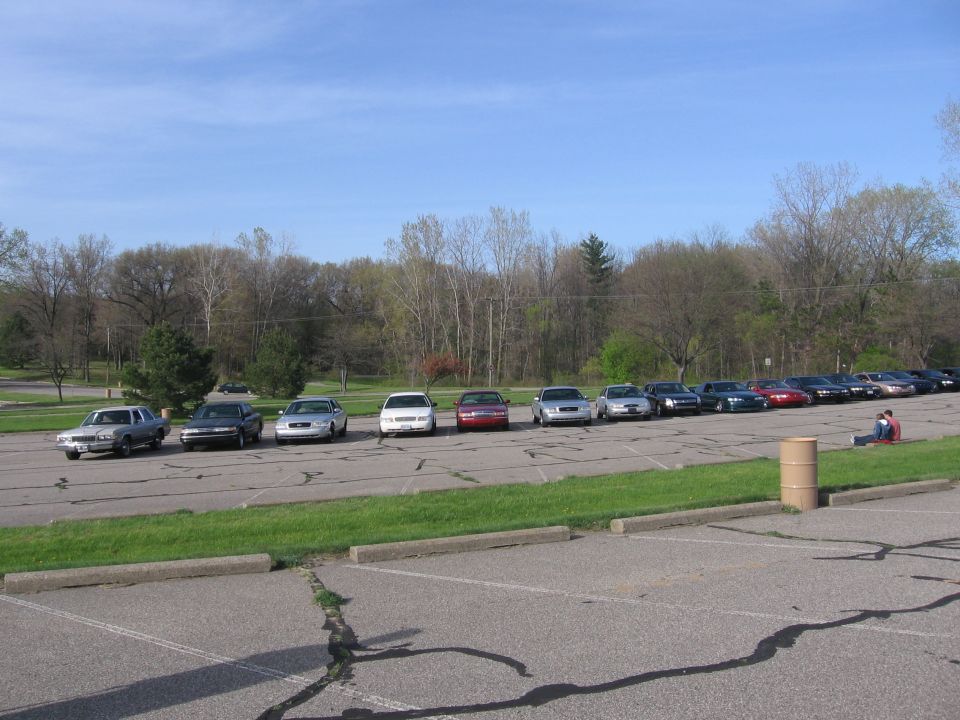 Silver 1988 Mercury Grand Marquis parked in a line of cars, side view
