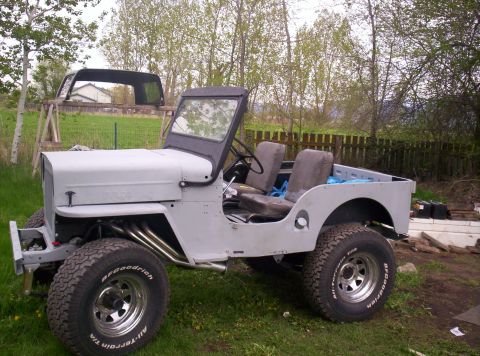 1954 Jeep CJ5 - This Jeep CJ-3A appears to be undergoing restoration, with its body primed and custom exhaust visible.