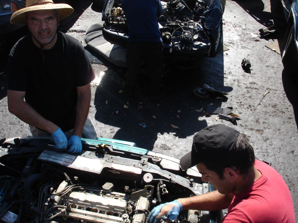 Engine bay with two men working on it