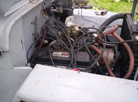 1954 Jeep CJ5 - The engine bay of a vehicle, a V8 engine with a prominent '350' badge.