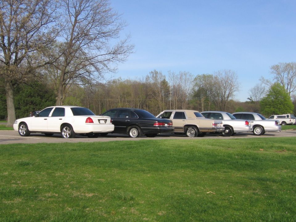 White 1988 Mercury Grand Marquis side view, parked with other sedans