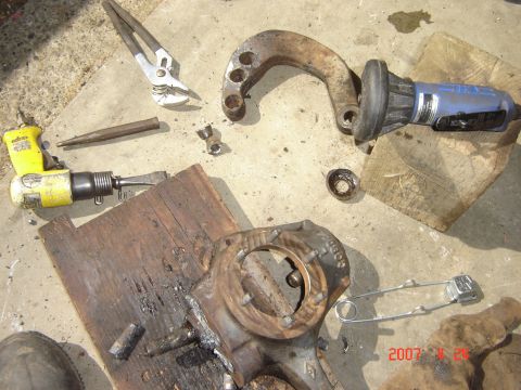 1993 Ford Bronco - Tools and disassembled vehicle parts are laid out on a concrete surface, suggesting a repair or maintenance job.