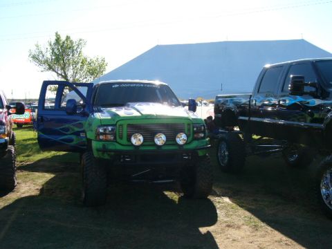 1978 Ford Bronco - Modified Ford F-Series truck with custom paint and lifted suspension is parked outdoors.