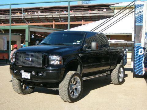 1978 Ford Bronco - This black Ford F-250 Super Duty pickup truck features a lifted suspension and large chrome wheels.