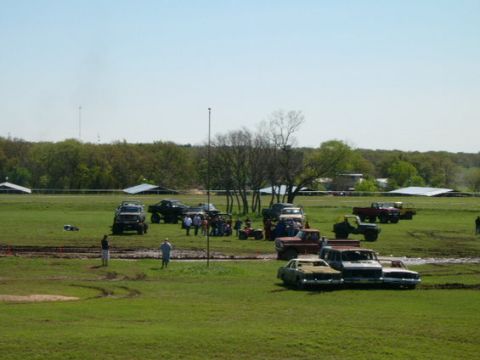 1978 Ford Bronco - A collection of trucks and cars are gathered in a field, possibly for an off-road event.