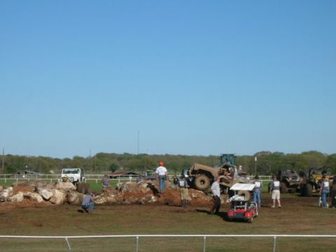 1978 Ford Bronco - Multiple off-road vehicles and participants are engaged in an activity on a challenging rocky terrain.