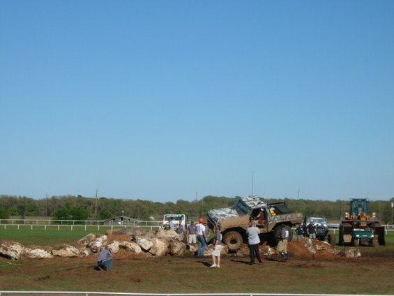 1978 Ford Bronco with camouflage paint on rocky obstacle course