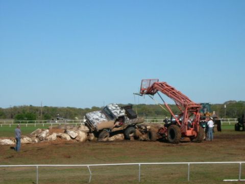 1978 Ford Bronco - A 1978 Ford Bronco attempts to navigate a rocky obstacle course, assisted by a loader.