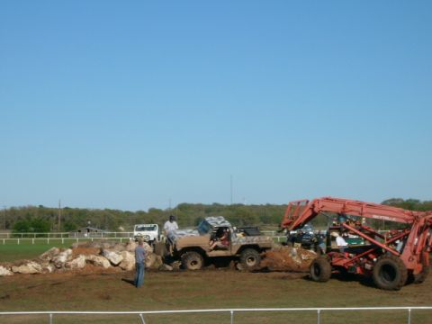 1978 Ford Bronco - An off-road vehicle attempts to maneuver through a challenging dirt and rock obstacle course.