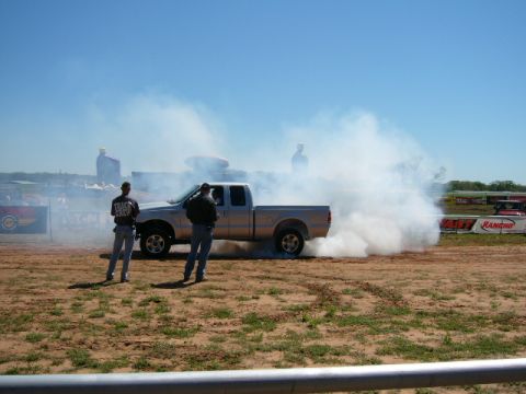 1978 Ford Bronco - A silver pickup truck creates a massive smoke screen during a burnout event.