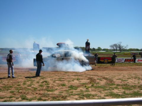 1978 Ford Bronco - A truck performs a burnout, kicking up a large cloud of smoke during an outdoor event.