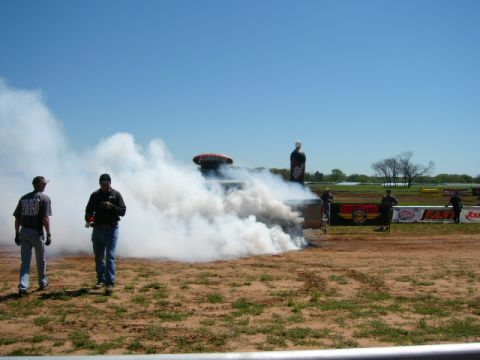 1978 Ford Bronco - Smoke fills the air during a burnout at a track event.