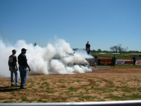 1978 Ford Bronco - A vehicle creates a large cloud of smoke during an event on a sunny day.