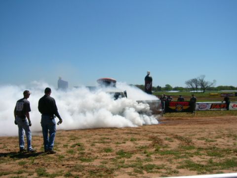 1978 Ford Bronco - A truck is engulfed in smoke during a burnout at a drag strip event.