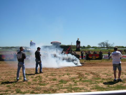 1978 Ford Bronco - Spectators observe a burnout event with a vehicle producing significant smoke.