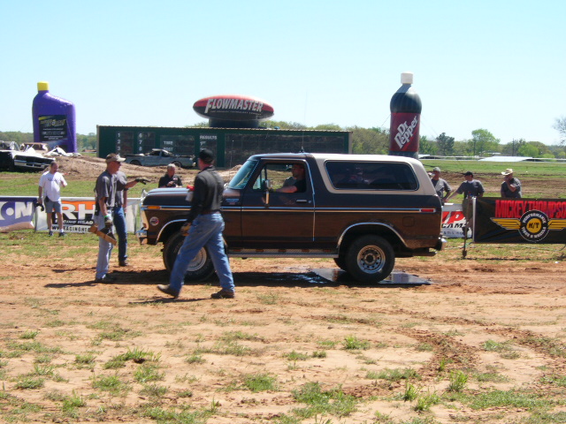 1978 Ford Bronco parked on dirt with people around it