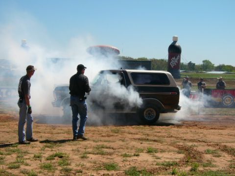 1978 Ford Bronco - A 1978 Ford Bronco performs a burnout, surrounded by smoke and onlookers.
