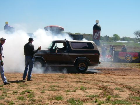 1978 Ford Bronco - A 1978 Ford Bronco performs a burnout on a dirt track.
