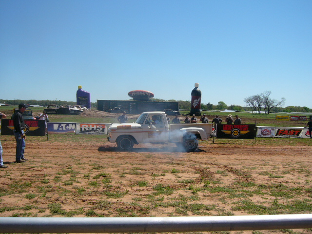 1978 Ford F-150 pickup truck doing a burnout, smoke coming from rear tires